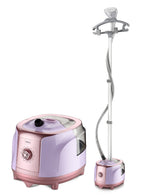 A pink and lavender steam ironing machine shown with its detachable steam wand and hanger stand on a plain white background.